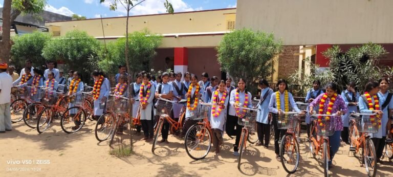 Students seated with bicycles on campus